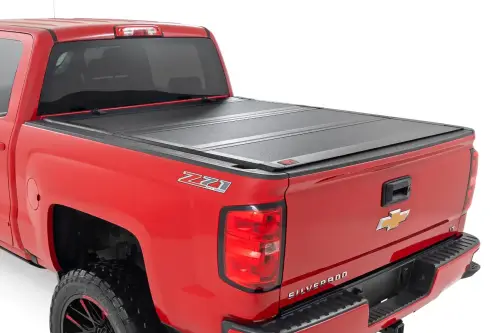 Rough Country - 49119551 | Rough Country Hard Tri-Fold Flip Up Tonneau Bed Cover For Chevrolet Silverado / GMC Sierra 1500/2500 HD/3500 HD | 2014-2019 | 5' 9" Bed With Rail Clips