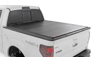 49214550 | Rough Country Hard Tri-Fold Flip Up Tonneau Bed Cover For Ford F-150 2WD/4WD | 2004-2014 | 5'7" Bed