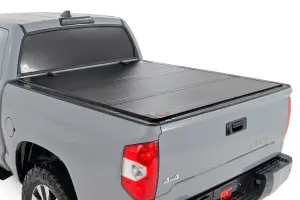49414551 | Rough Country Hard Tri-Fold Flip Up Tonneau Bed Cover For Toyota Tundra | 2007-2021 | 5' 7" Bed