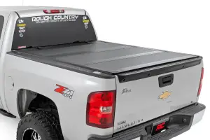 Rough Country - 49113551 | Rough Country Hard Tri-Fold Flip Up Tonneau Bed Cover For Chevrolet Silverado 1500 / GMC Sierra 1500/1500 Denali (2007-2013) | 5' 9" Bed With Rail Caps - Image 1